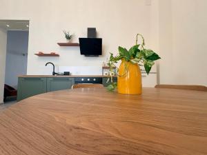 Eine orangefarbene Vase steht auf einem Tisch in der Unterkunft Isula Antica in Floridia