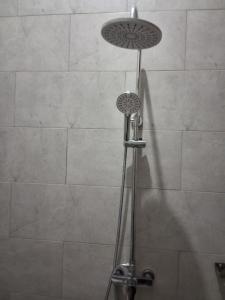 a shower with a shower head in a bathroom at Yigs Motel in Iringa +21 photos