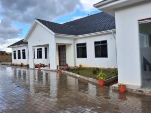 a house in flood water in front of it at Yigs Motel in Iringa