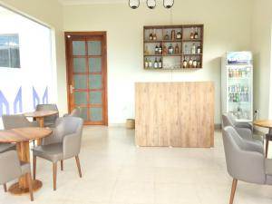a restaurant with tables and chairs and a wooden door at Yigs Motel in Iringa