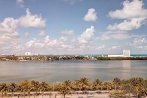 a view of a river with palm trees and a city at Royalton CHIC Cancun, An Autograph Collection All-Inclusive Resort - Adults Only in Cancún