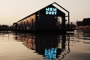 a building sitting on top of a body of water at New Port Apartments on the River in Krakow