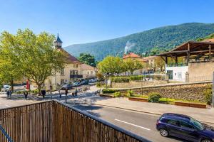 a car driving down a street in a town at Studio cosy avec extérieur CHU in La Tronche