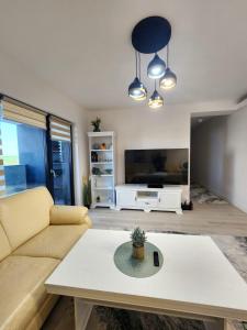 a living room with a couch and a table at Luxury apartment Avanera in Suceava