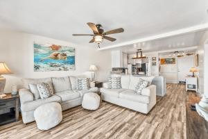 a living room with a couch and a ceiling fan at Oceanfront St Helena Island Condo w/ Beach Access! in Oceanmarsh Subdivision