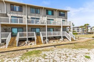 aominium building with white railings on the beach at Oceanfront St Helena Island Condo w/ Beach Access! in Oceanmarsh Subdivision