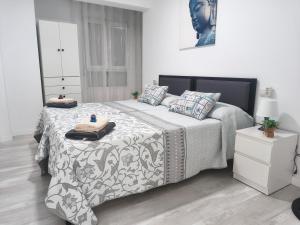 a bedroom with a bed with two pillows on it at Apartamento Grao in Gandía
