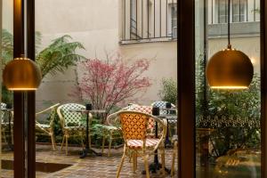 a view of a table and chairs from a window at Hôtel le 6 Tiquetonne in Paris