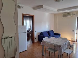 a living room with a table and a blue couch at Campania Home in Terni