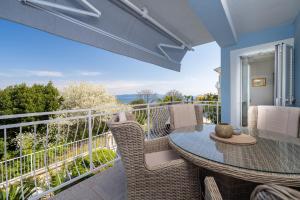 a patio with a table and chairs on a balcony at Villa Bella Vista - apartments in Labin