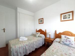 two beds in a room with white walls at ALCAUDÓN By SIT ISLA CANELA -REF 282- in Ayamonte +7 photos