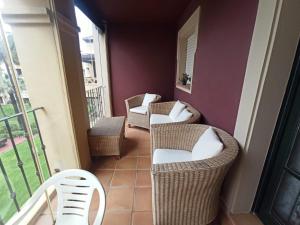 a balcony with two wicker chairs and a balcony at ALCAUDÓN By SIT ISLA CANELA -REF 282- in Ayamonte