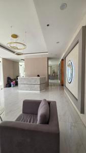 a living room with a couch in the middle at Kim's Cozy Place - Parthenon Residences in Cebu City