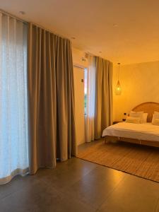 a bedroom with a bed and a large window at Anba Solēy in Surinam +53 photos