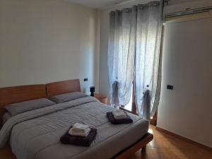 a bedroom with a large bed with towels on it at Campania Home in Terni