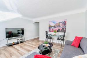 a living room with a couch and a table at Central Corktown Apartment for City Explorers in Hamilton