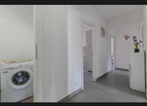 a white laundry room with a washing machine in it at Casa Gaia a soli 20 mt dal mare in Pomonte +9 photos