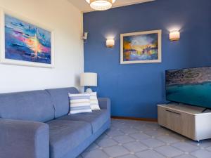 a living room with a couch and a flat screen tv at Villa Gino in Stintino