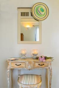 a dressing table with two candles and a mirror at Keablue in Melissaki