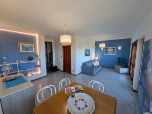 a living room with a table and a couch at Villa Gino in Stintino