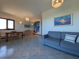a living room with a blue couch and a table at Villa Gino in Stintino