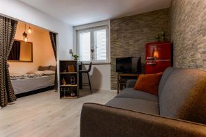 a living room with a couch and a bedroom at Boutique Suite 02 Chic in Zadar