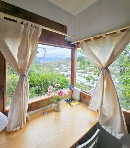 an office with a desk with a window with a view at Hiên nhà Đà Lạt in Ấp Kim Thạch
