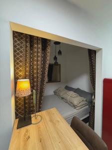 a room with a bed and a table with a lamp at Boutique Suite 02 Chic in Zadar