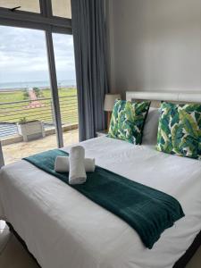 a bedroom with a large bed with a large window at Durban Point Waterfront, 304 The Quays in Durban +38 photos