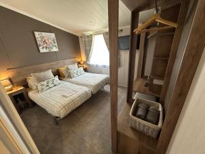 a small room with a bed and a couch at Luxury Lakeside Lodge L2 with Hot tub situated at Tattershall Lakes Country Park in Tattershall +23 photos