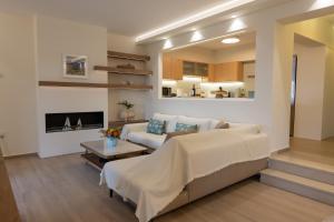 a living room with a bed and a couch at Seafront Villa Ciel with Private Pool in Nafpaktos in Nafpaktos +34 photos