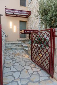 a red gate in front of a house at Seafront Villa Ciel with Private Pool in Nafpaktos in Nafpaktos