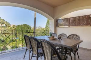 a dining room with a table and chairs on a balcony at BHost - Bellagio II in Benalmádena