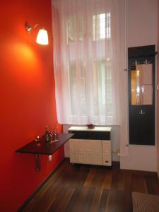 a red room with a table and a window at Miniapartman Budapest in Budapest