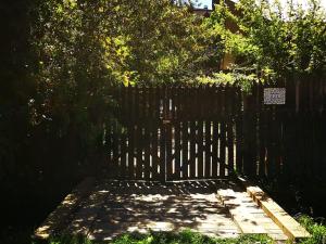 a wooden fence with a wooden walkway in a yard at Casa del Estero in Pucón +2 photos