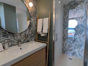 a bathroom with a sink and a mirror at Les Galets Hôtel et B&B in Bandol +99 photos