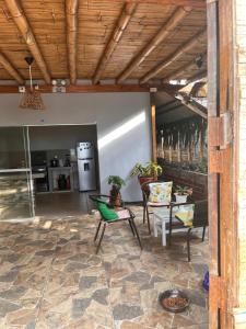 a patio with a table and chairs and a kitchen at HospedajesPerú in Zorritos