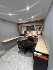 a kitchen with a table and chairs in a room at Smith House in Durban