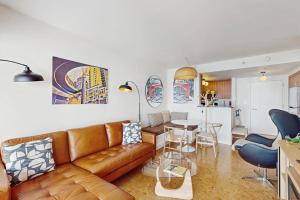 a living room with a brown leather couch and a table at Pike Place Pearl in Seattle