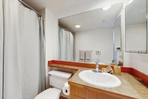 a bathroom with a sink and a toilet and a mirror at Pike Place Pearl in Seattle