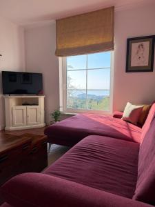 two beds in a room with a window and a tv at Apartment STAR Blažev in Primošten