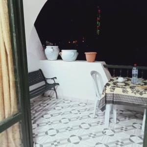 a balcony with a table and two bowls on a ledge at Bungalow kantaoui Sousse in Hammam Sousse +4 photos