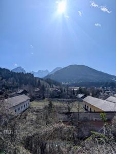 a group of buildings in a field with mountains in the background at Bosco Verde in Tarvisio +15 photos
