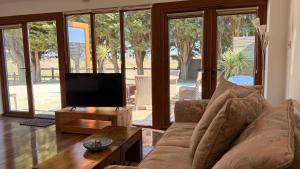 a living room with a couch and a flat screen tv at Converted Barn Studio with Private En-Suite in Horspath