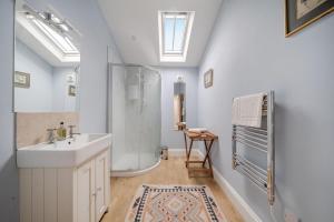 a bathroom with a shower and a sink at Blackmoor View Cottage in Sherborne +28 photos