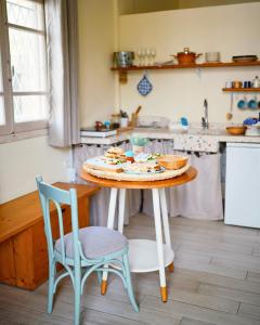 a kitchen with a table with a cake and two chairs at The Happinesst بيت فرح in Anfah