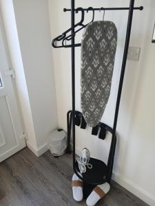a coat rack in a room next to a wall at Moodyscroft Homestay, NEC, BHX, Resorts world, HS2, JLR - Netflix in Birmingham +6 photos