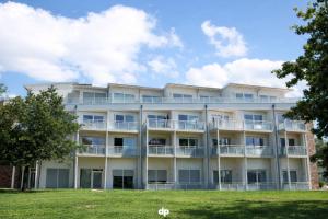an apartment building with balconies and trees at DUENENROSE App Nr 03 max 3 Pers in Dierhagen +1 photo
