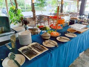 a blue table with plates of food on it at Klang Aow Resort in Khanom +107 photos