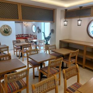 a dining room with wooden tables and chairs at B Suites Boutique Hotel in Amman